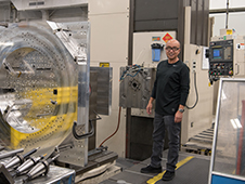 Oscar Avalos stands beside to the Mitsubishi MAF in the machine shop.