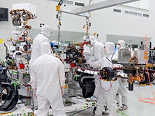 On June 21, 2019, engineers at NASA's Jet Propulsion Laboratory install the main robotic arm on the Mars 2020 rover