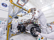 Engineers at JPL install the starboard legs and wheels