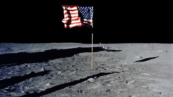 The U.S. flag stands alone on the surface of the moon.