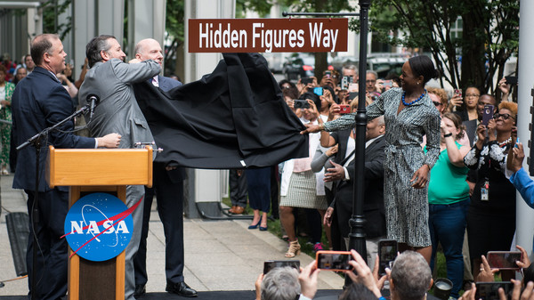 NASA Administrator Jim Bridenstine (from left to right), U.S. Senator Ted Cruz, R-Texas, D.C. Council Chairman Phil Mendelson, and Margot Lee Shetterly, author of the book Hidden Figures, unveil the "Hidden Figures Way" street sign at a dedication ceremony on Wednesday in Washington.