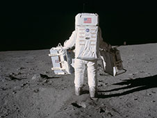 Astronaut Edwin E. Aldrin Jr. moves toward a position to deploy two components of the Early Apollo Scientific Experiments Package
