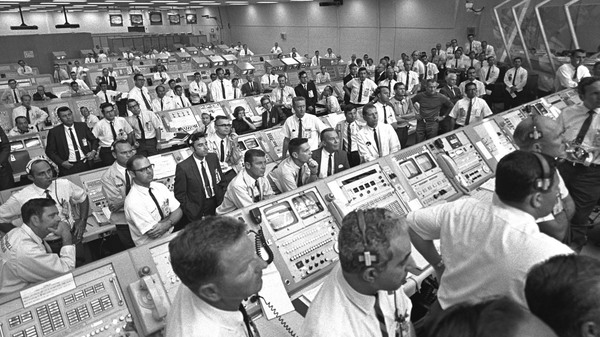 JoAnn Morgan (third row, middle) sits among other members of the Kennedy Space Center government-industry team in the firing room to watch the Apollo 11 liftoff. Morgan was the first woman permitted to be inside the firing room during an Apollo launch.