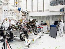 Engineers test cameras on the top of the Mars 2020 rover's mast and front chassis.