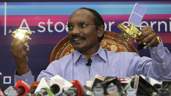 Indian Space Research Organization (ISRO) Chairman Kailasavadivoo Sivan displays a model of Chandrayaan 2 orbiter and rover during a press conference at their headquarters in Bangalore, India onÂ Aug. 20.