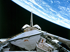 The Space Shuttle Endeavor flying upside-down with SIR-C/X-SAR