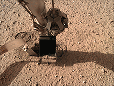 Animated gif of NASA InSight's robotic arm uses its scoop to pin the spacecraft's heat probe, or