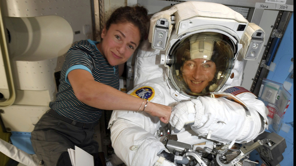 Astronauts Christina Koch (right) and Jessica Meir pose for a photo on the International Space Station on Oct. 4. NASA moved up the first all-female spacewalk because of a power system failure at the space station.