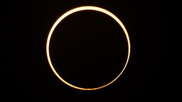 The moon moves in front of the sun in a rare "ring of fire" annular solar eclipse, as seen in the sky over Singapore, Thursday, Dec, 26.
