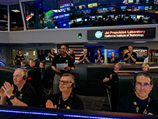 Spitzer Project Scientist Joseph Hunt stands in Mission Control