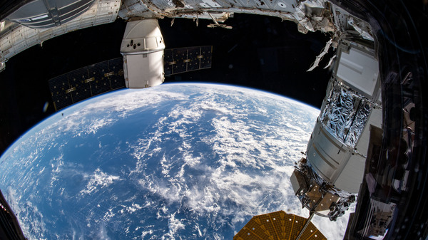 The SpaceX Dragon cargo spacecraft that ferried musclebound mice to the International Space Station and back can be seen at the top of this picture taken from the station on Dec. 20, 2019.