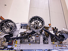 Three of the six flight wheels that will travel to Mars can be seen attached to NASA's Perseverance rover