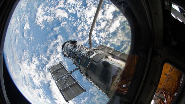 An STS-125 crew member onboard the Space Shuttle Atlantis snapped a still photo of the Hubble Space Telescope following grapple of the giant observatory by the shuttle.