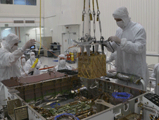 Engineers lower MOXIE into the belly of NASA's Perseverance rover