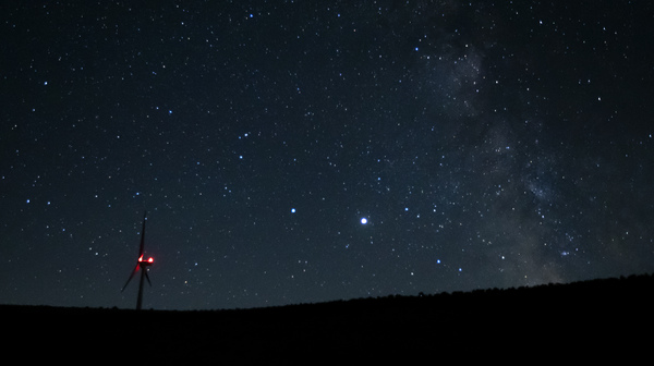 Saturn (center-left) and Jupiter (center-right) share a night sky earlier this year near Vantage, Wash. Already this past summer, the two planets were growing closer in the night sky. Later this month, they will appear closer to each other than they have for centuries.