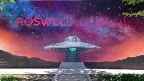 A mural in Roswell, N.M., displays the town slogan. A mysterious aircraft crash in 1947 led to the local legend of visitors from another planet.