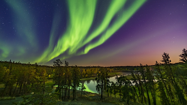 The northern lights as seen from the Cameron River viewpoint off the Ramparts falls trail on the Ingraham trail near Yellowknife, Canada.