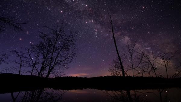 A scenic view of a lake against the sky at night in British Columbia. Earlier this month, a resident of Golden, B.C., woke up to the sound of a crash and found that a meteorite had landed in her bed.