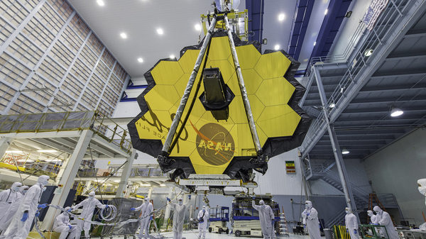 Technicians lift the mirror of the James Webb Space Telescope using a crane at the Goddard Space Flight Center in Greenbelt, Md., in April 2017. On Saturday, the telescope completed its final deployment in space.