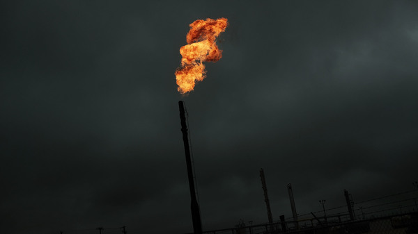 Flared natural gas is burned off at a natural gas plant. Methane, the main ingredient in natural gas, can leak from natural gas plants and pipelines.