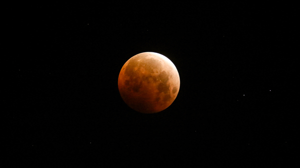 Light shines from a total lunar eclipse over Santa Monica Beach, Calif., in May 2021.