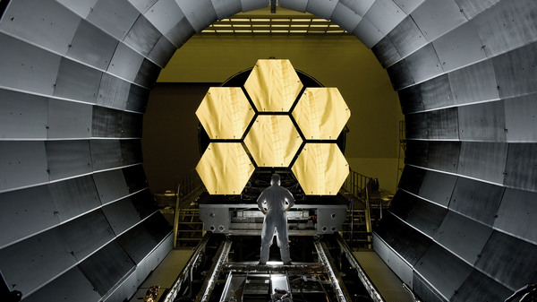 NASA engineer Ernie Wright looks on as the first flight-ready mirrors for the James Webb Space Telescope are prepared to undergo testing.