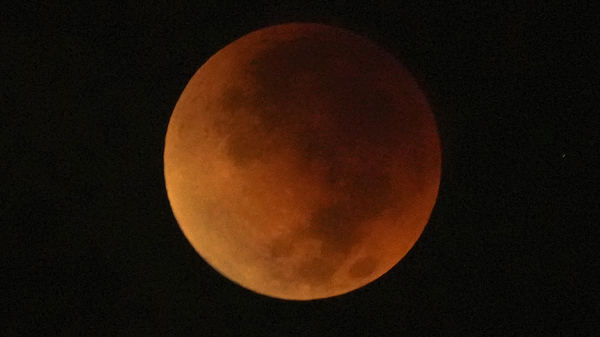 A total lunar eclipse graces the night skies during the first blood moon of the year, in Brasilia, Brazil, Sunday, May 15, 2022.