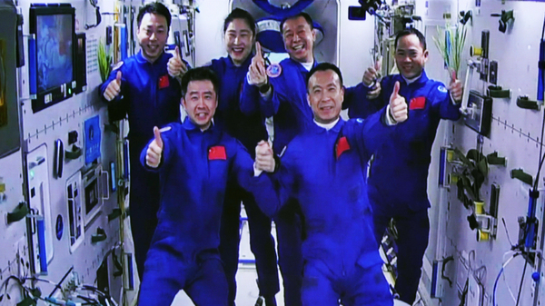 In this photo released by Xinhua News Agency, the Shenzhou-15 and Shenzhou-14 crew take a group picture after a historic gathering in space on Nov. 30.