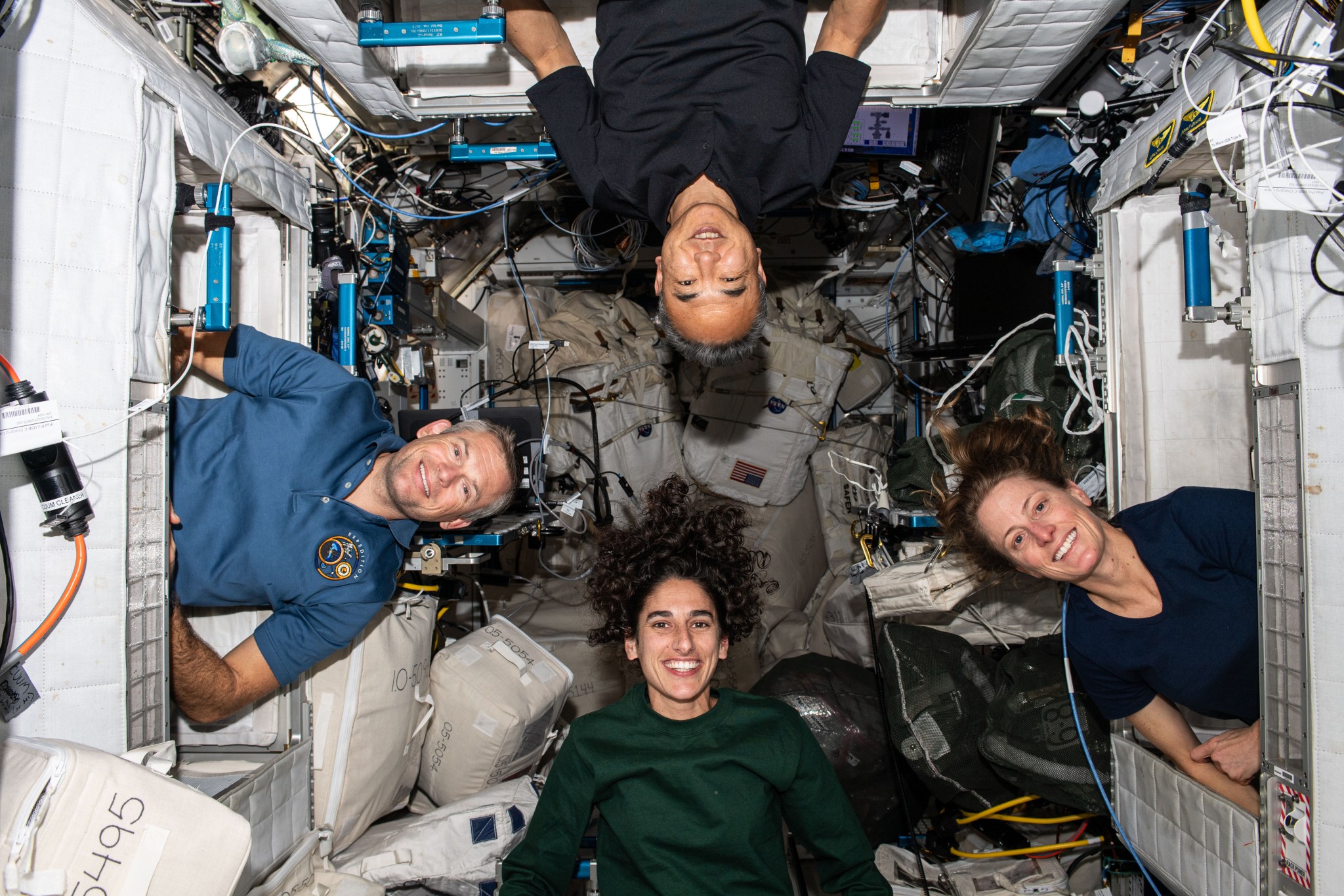 Four Expedition 70 crew members pose for a fun portrait inside their crew quarters aboard the International Space Station's Harmony module. Clockwise from bottom are, NASA astronaut Jasmin Moghbeli; ESA (European Space Agency) astronaut Andreas Mogensen; JAXA (Japan Aerospace Exploration Agency) astronaut Satoshi Furukawa; and NASA astronaut Loral O'Hara.