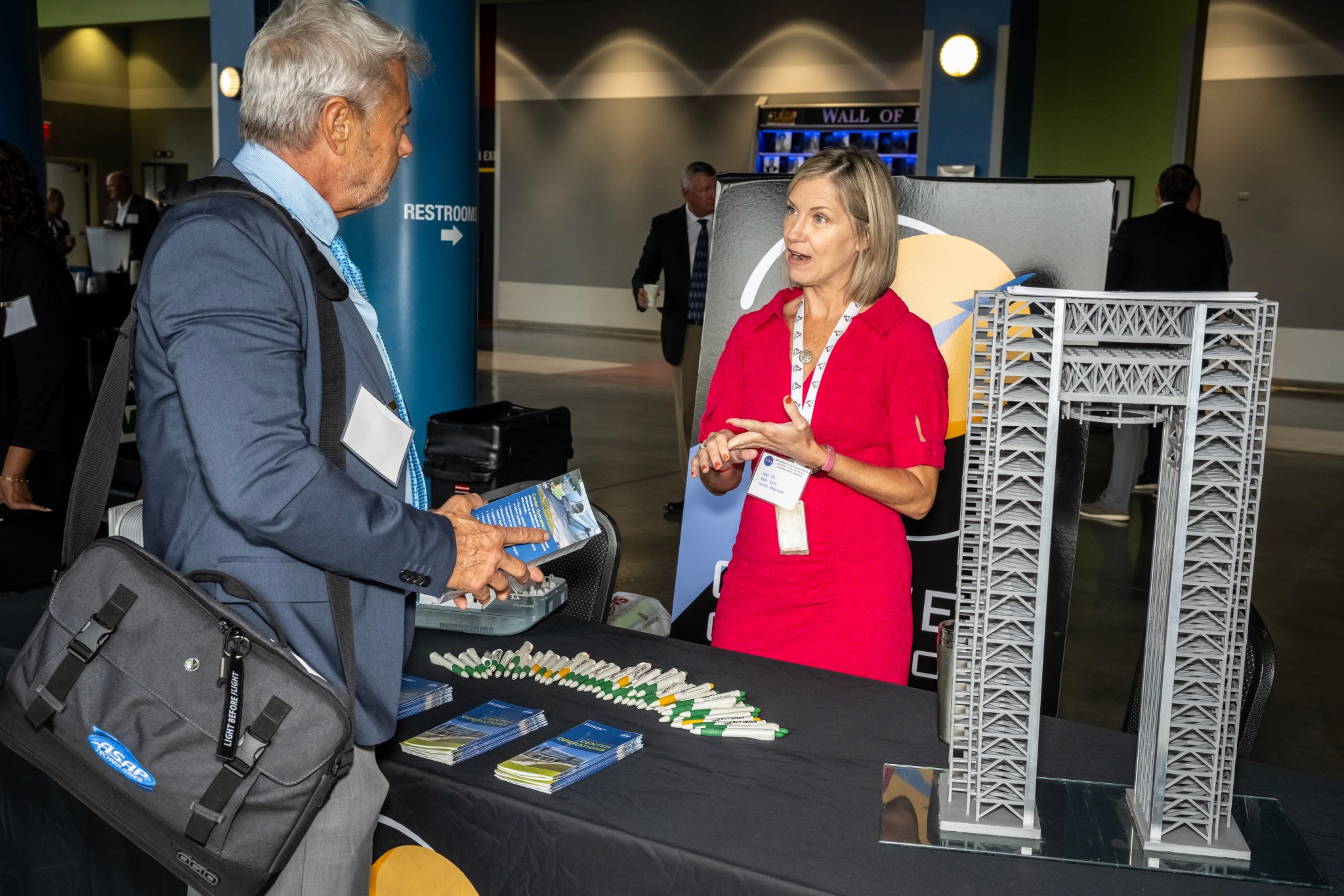 Leah Fox, program specilaist for Marshall’s Center Operations talks with an attendee of the 36th Marshall Small Business Alliance Meeting.