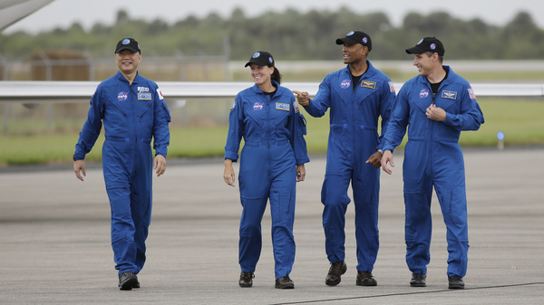 From left, astronaut Soichi Noguchi of Japan and NASA astronauts Shannon Walker, Victor Glover and Michael Hopkins walk after arriving at Kennedy Space Center in Cape Canaveral, Fla. The four astronauts will fly on the SpaceX Crew-1 mission to the International Space Station scheduled for launch on Saturday.