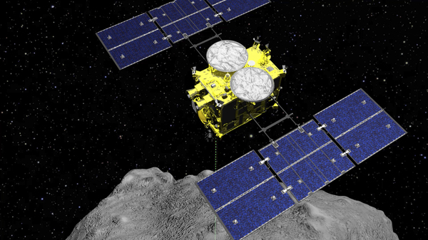 This computer-generated image shows the Hayabusa2 spacecraft above the asteroid Ryugu. This weekend, the sample collected by the spacecraft is expected to fall to Earth after a six-year mission.