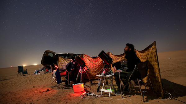 Kuwaiti photographers follow the alignment between Jupiter and Saturn in al-Salmi district, a desert area about 75 miles west of Kuwait City, on Monday.