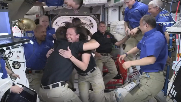 In this image provided by NASA, SpaceX astronauts are greeted by those already aboard the International Space Station after the Dragon capsule successfully docked on Saturday. Their arrival brings the total number of astronauts on the station to a recent high of 11.