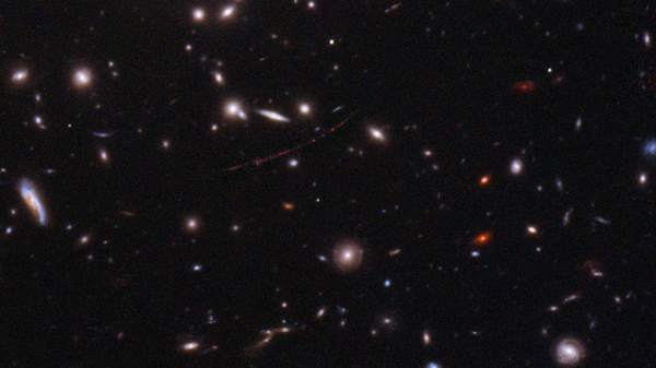 The Hubble Space Telescope has spotted the farthest star ever seen. The magnified galaxy looks like a stretched out red line with three dots. The single star is the middle one.