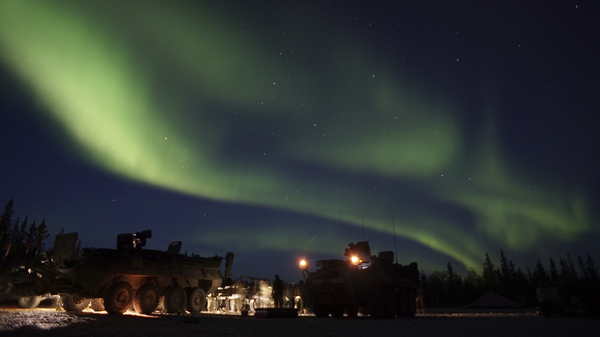 In this Sept. 15, 2017 photo provided by the U.S. Army Alaska, soldiers from Alpha Company, 70th Brigade Engineer Battalion, 1st Stryker Brigade Combat Team, 25th Infantry Division, based at Fort Wainwright, Alaska, conduct unscheduled field maintenance under the Northern Lights on a squad vehicle in preparation for platoon external evaluations at Donnelly Training Area, near Fort Greely, Alaska.