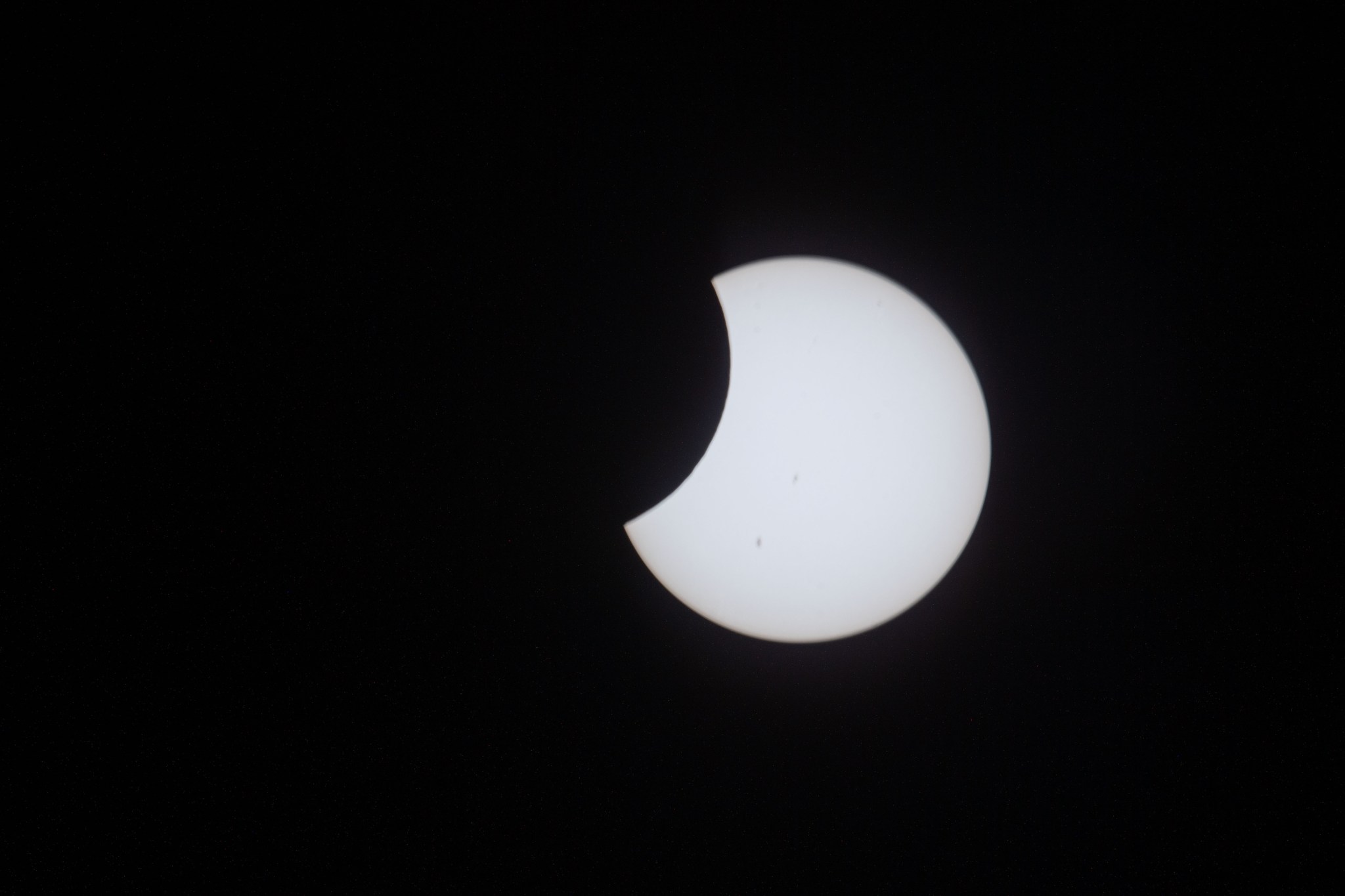 The Moon passes in front of the sun during the annular solar eclipse in this photograph taken by Expedition 70 Flight Engineer Jasmin Moghbeli aboard the International Space Station.