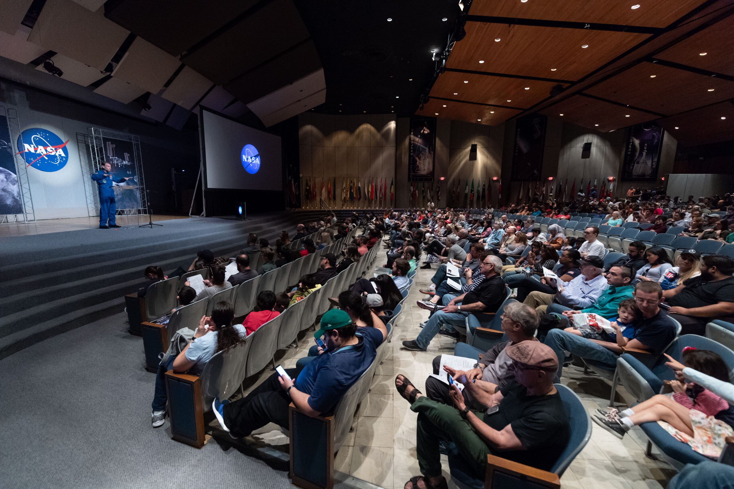 Visitors to NASA’s Johnson Space Center Open House 2018 listen to an astronaut in Teague Auditorium.